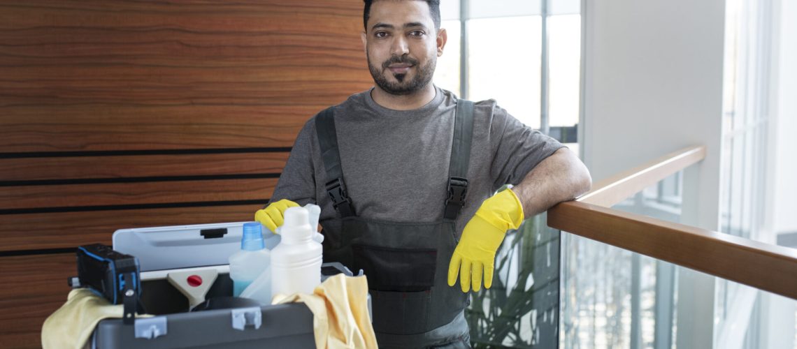 medium-shot-smiley-man-with-cleaning-cart